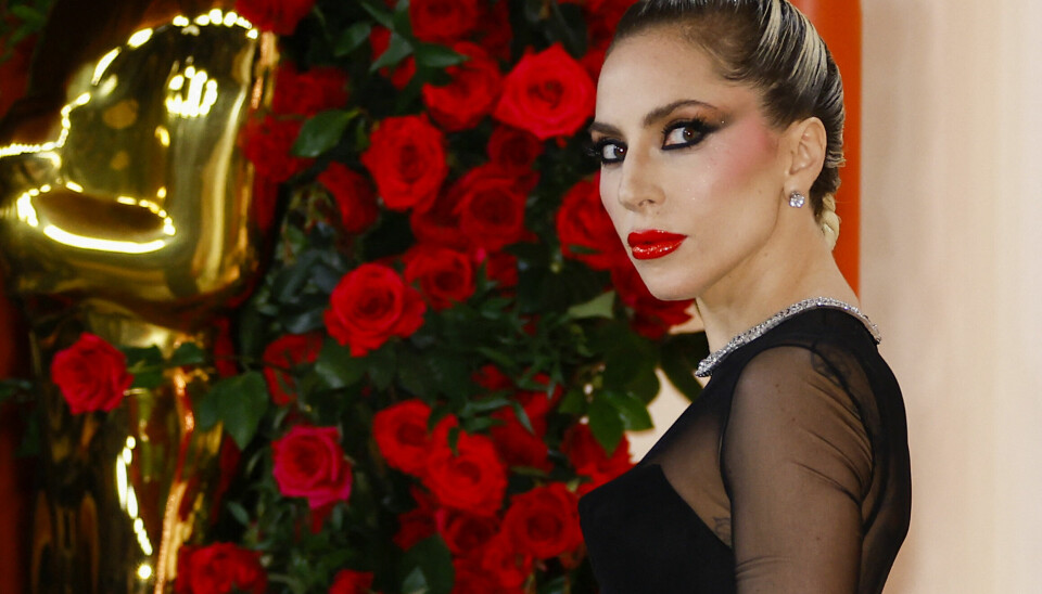 Lady Gaga poses on the champagne-colored red carpet during the Oscars arrivals at the 95th Academy Awards in Hollywood, Los Angeles, California, U.S., March 12, 2023. REUTERS/Eric Gaillard