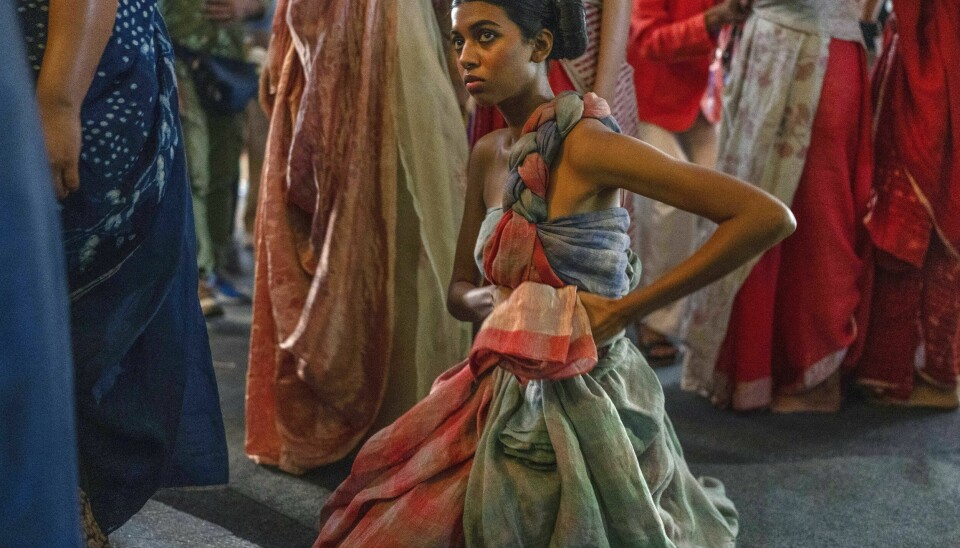 A model takes a break backstage before the start of a show during Lakme Fashion Week X FDCI in Mumbai, India, Thursday, March 9, 2023. From the front-row seats, fashion shows could be mistaken for a spectacular party with models sashaying down the ramp in stunning ensembles. But this confluence of fashion, designers, celebrities and buyers is hardly possible without an army of people furiously working behind the scenes to make sure the show goes smoothly. (AP Photo/Rafiq Maqbool)