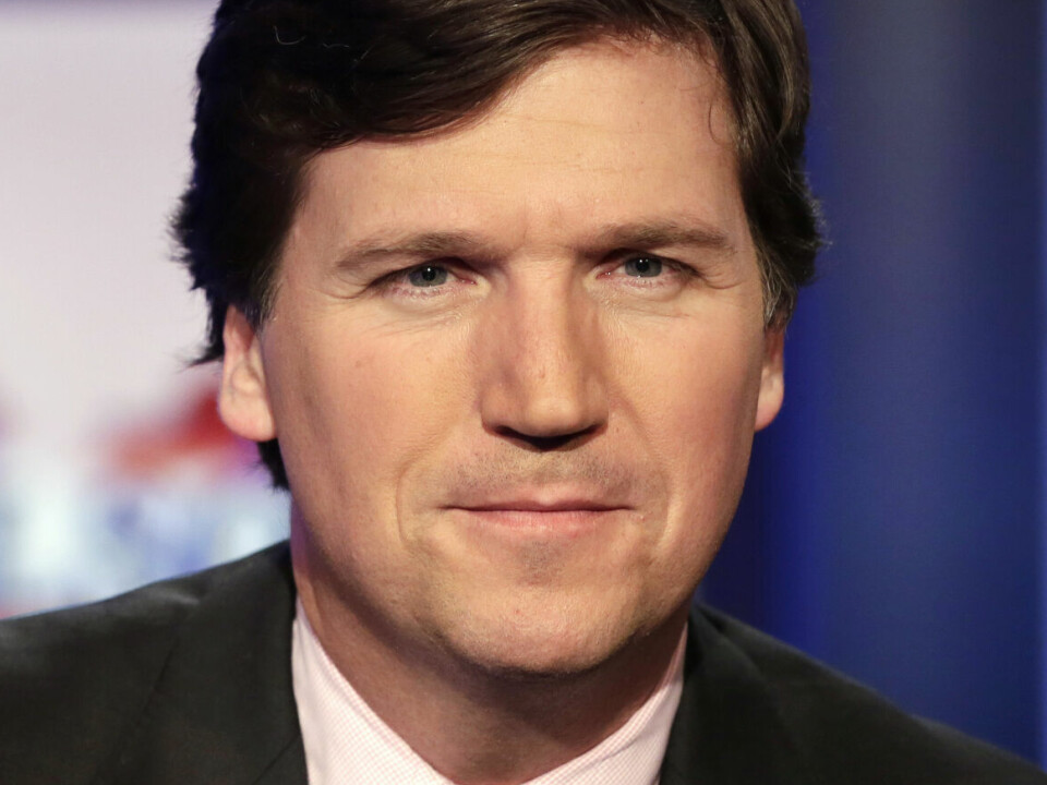 FILE - Tucker Carlson, host of 'Tucker Carlson Tonight,' poses for photos in a Fox News Channel studio on March 2, 2017, in New York. A racist text message from Tucker Carlson is what helped drive the commentator's ouster from Fox News, The New York Times reports. The Times says that in a text uncovered as part of a recent defamation lawsuit, the former Fox host lamented how supporters of former President Donald Trump ganged up to beat a protester. “It's not how white men fight,” Carlson wrote. (AP Photo/Richard Drew, File)