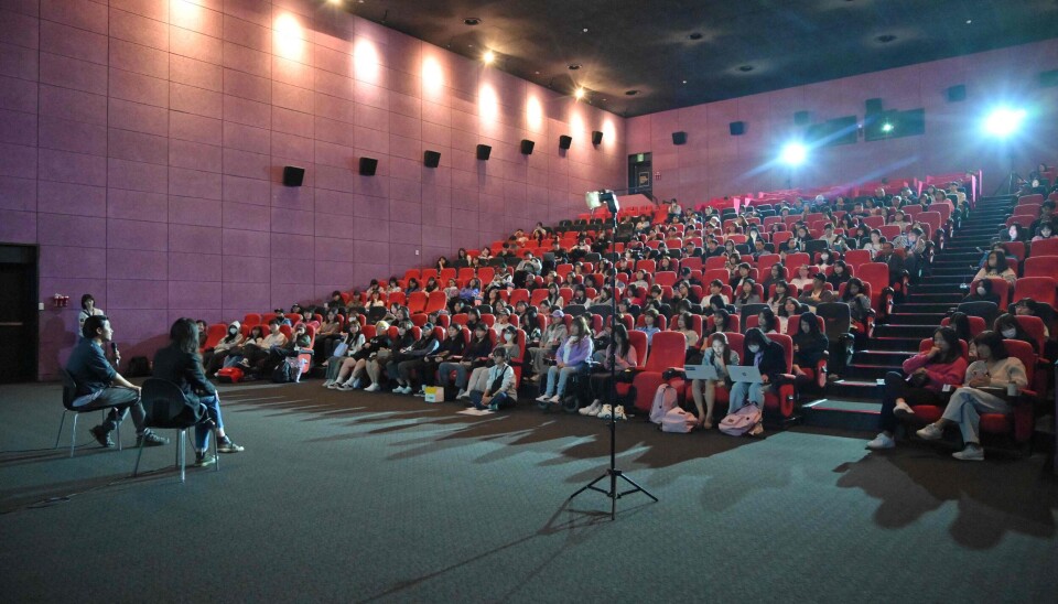 In this photo taken on October 7, 2023, South Korean actor Jung Yoon-suk (L), director of 'Dear Jinri', answers questions during a guest visit event, after a screening of the film at the Busan International Film Festival (BIFF) in Busan. A new documentary featuring a late K-pop star's final interview unveils complex truths about the notoriously brutal K-pop industry and the cost of defying South Korean cultural norms. (Photo by Yelim LEE / AFP)