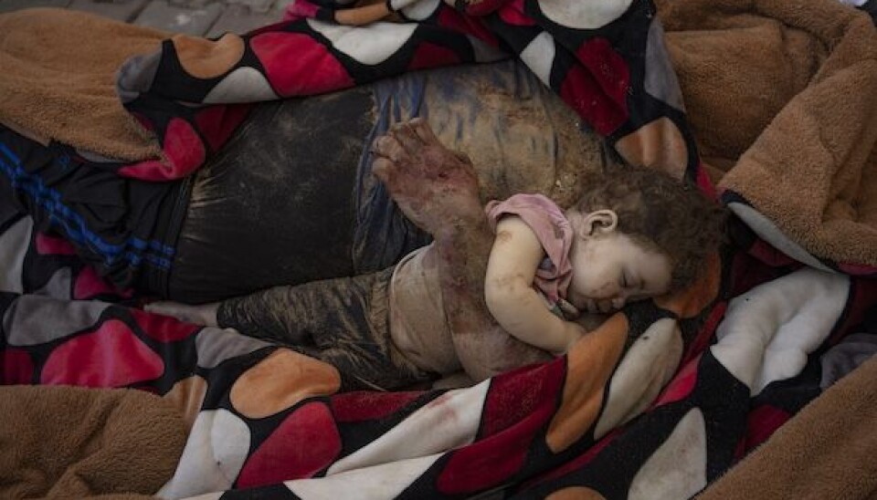 The bodies of a father and his child killed in the Israeli bombardment of the Gaza Strip, lie in front of the morgue at Al-Aqsa Hospital in Deir Al-Balah, Sunday, Oct. 22, 2023. ( AP Photo/Fatima Shbair)