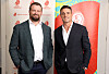 James Slipper and Dan Carter stand posing in front of Rugby World Cup draw branding at Channel Nine Studios.